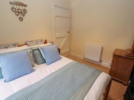 A bedroom with a bed and chest of drawers at Easthwaite Cottage Holmrook near Easthwaite Farm