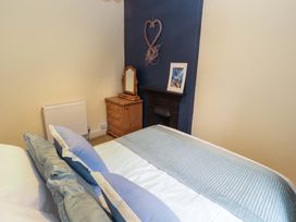 A bedroom with a bed and dresser at Easthwaite Cottage Holmrook near Easthwaite Farm