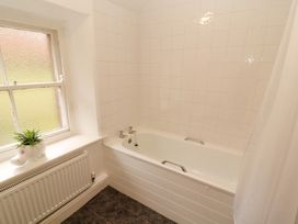A bathroom with a bathtub and window at Easthwaite Cottage in Holmrook near Easthwaite Farm