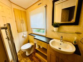 A bathroom with a sink and toilet at Plot 293 Caravan Weybourne near Sheringham