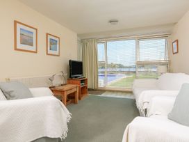 A living room with a sofa and television at 3 The Salcombe in Salcombe
