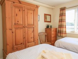 A bedroom with a wardrobe and a chest of drawers at 3 The Salcombe in Salcombe