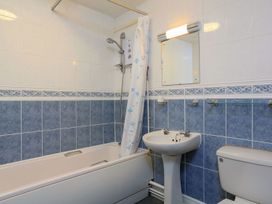A bathroom with a shower, bathtub, sink, and toilet at 3 The Salcombe Salcombe