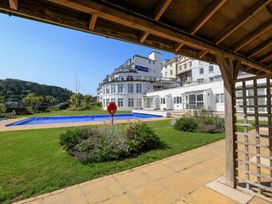 An outdoor area with a swimming pool and landscaping at 3 The Salcombe Salcombe