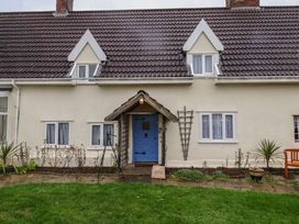 A house with a blue door and windows at Driftway Cottage in Diss