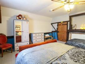 A bedroom with a wardrobe and two beds at Driftway Stables Retreat in Diss