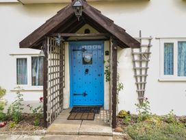 A blue door with a trellis next to it at Driftway Stables Retreat in Diss