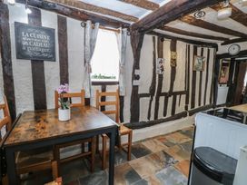 A kitchen with a wooden table and chairs at Driftway Stables Retreat, Diss