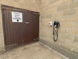 A parking sign and electric charging station at Driftway Stables Retreat in Diss