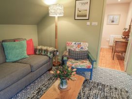 A living room with sofa and chair at Golden Valley View in Stroud