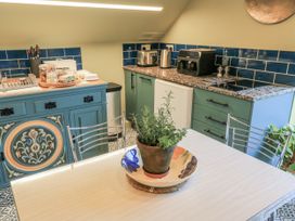 A kitchen with a table and plant at Golden Valley View in Stroud