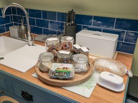 A kitchen sink with jars and food items on a cutting board at Golden Valley View in Stroud