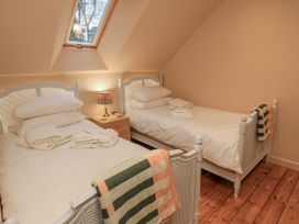 A bedroom with two beds and a window at Golden Valley View, Stroud