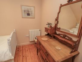 A bedroom with a bed and dressing table at Golden Valley View in Stroud