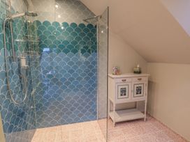 A bathroom with a shower and cabinet at Golden Valley View in Stroud