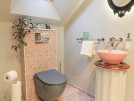 A bathroom featuring a toilet, sink with faucet, and hand towel at Golden Valley View in Stroud