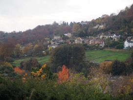A view of houses and trees on a hillside at Golden Valley View, Stroud