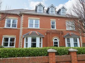 A house with multiple windows and a brick wall at Flat 7 Weymouth