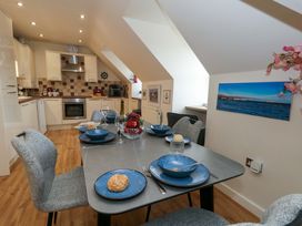 A kitchen with a dining table set for a meal at Flat 7 Weymouth