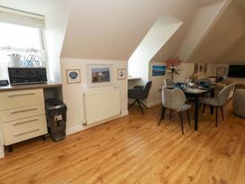 A dining area with a table and chairs at Flat 7 in Weymouth