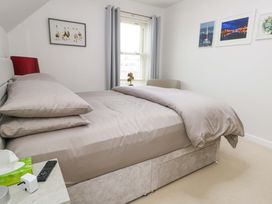 A bedroom with a bed and window at Flat 7 in Weymouth