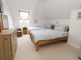 A bedroom with two beds and a dresser at Flat 7 in Weymouth