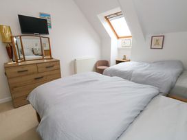 A bedroom with two beds and a dresser at Flat 7 Weymouth