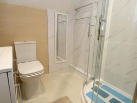 A bathroom with a shower and toilet at Flat 7 Weymouth