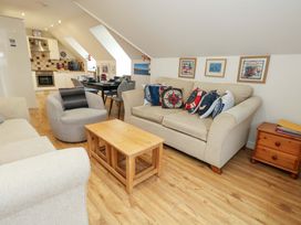 A living room with a sofa and coffee table at Flat 7 Weymouth