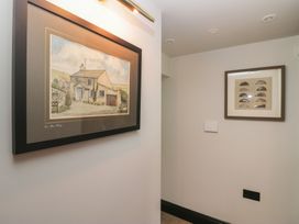 A hallway with framed pictures on the walls at Low House Cottage Ayside near Newby Bridge