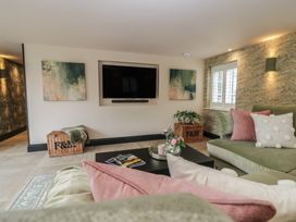 A living room with a television and seating area at Low House Cottage Ayside near Newby Bridge