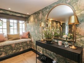 A hallway with a mirror and table at Low House Cottage Ayside near Newby Bridge