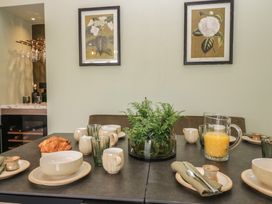 A dining room with a table set for breakfast at Low House Cottage in Ayside near Newby Bridge