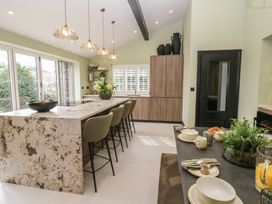 A kitchen with an island and bar stools at Low House Cottage Ayside near Newby Bridge