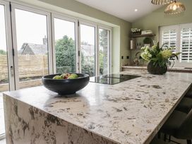A kitchen with an island and bowl of apples at Low House Cottage Ayside near Newby Bridge