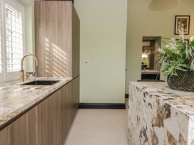 A kitchen with a sink and faucet at Low House Cottage Ayside near Newby Bridge