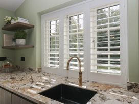 A kitchen with a sink and window at Low House Cottage Ayside near Newby Bridge