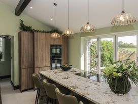 A kitchen with an island and bar stools at Low House Cottage Ayside near Newby Bridge