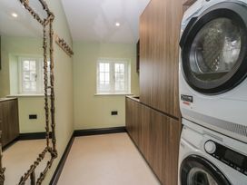 A laundry room with a washing machine and tumble dryer at Low House Cottage Ayside near Newby Bridge
