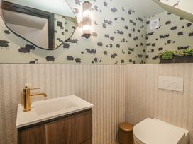 A bathroom with a sink, toilet, and mirror at Low House Cottage Ayside near Newby Bridge