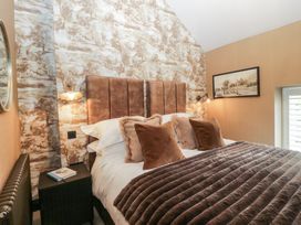 A bedroom with a bed and bedside table at Low House Cottage Ayside near Newby Bridge