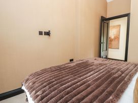 A bedroom with a bed covered in a blanket at Low House Cottage Ayside near Newby Bridge