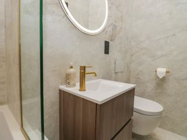 A bathroom with a sink, toilet, and shower at Low House Cottage Ayside near Newby Bridge