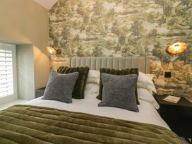 A bedroom with a bed and nightstand at Low House Cottage Ayside near Newby Bridge