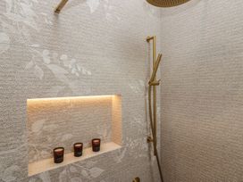 A shower area with candles in a niche at Low House Cottage Ayside near Newby Bridge
