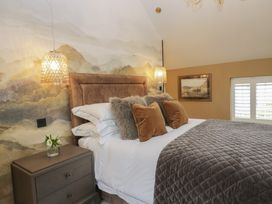 A bedroom with a bed and bedside table at Low House Cottage Ayside near Newby Bridge