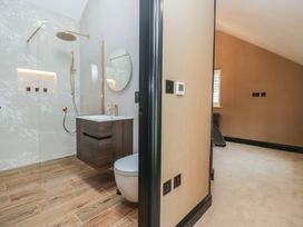 A bathroom with a shower and toilet visible at Low House Cottage Ayside near Newby Bridge