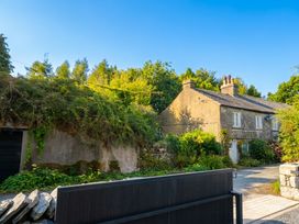 A house with a garden and gate at Low House Cottage in Ayside near Newby Bridge