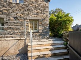 A stone exterior with steps and plants at Low House Cottage Ayside near Newby Bridge