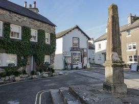 A street view with buildings and a sign at Low House Cottage Ayside near Newby Bridge